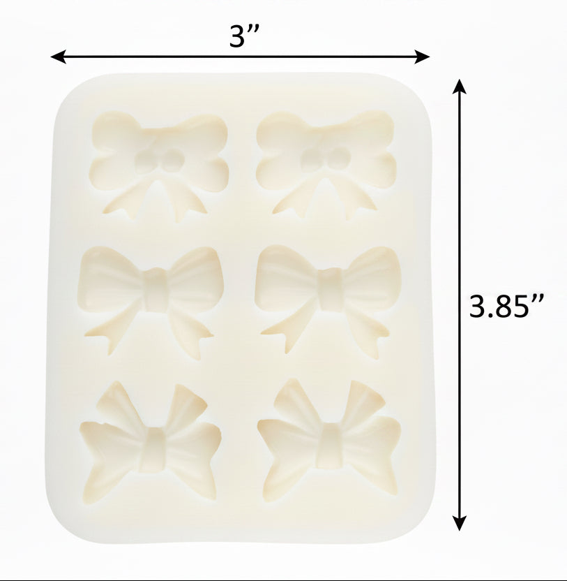 A pale mint green silicone mold with six embossed bow-shaped cavities, shown against a plain white background.