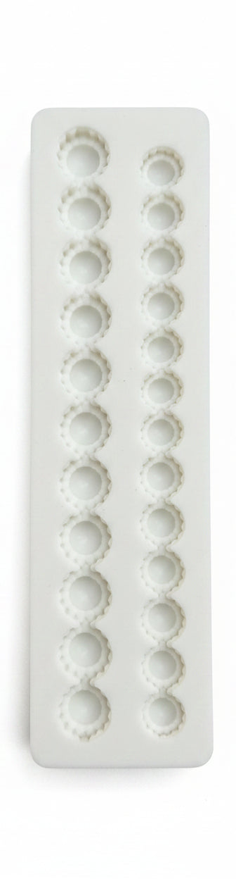White decorative strip with circular patterns on a black textured background
